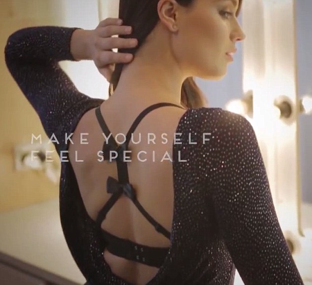 Too good to be true: As she seductively fixes her hair while standing at a vanity table, her fine figure is once again on display