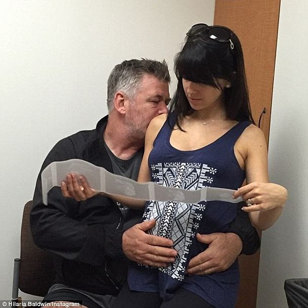 Surveying sonograms: The expecting 31-year-old and husband Alec Baldwin will welcome their second child together - a son - in July