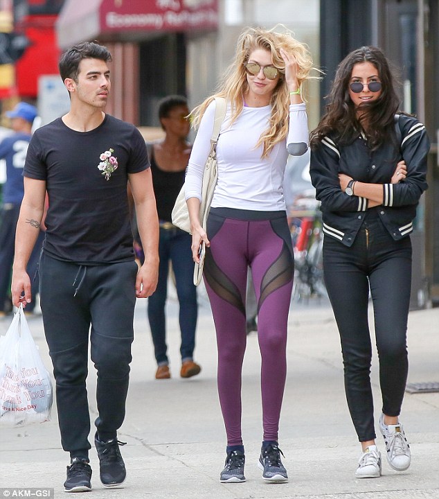 He's tangled in! 25-year-old Jonas was fixated at one point to Gigi's, 20,  wavy blonde strands