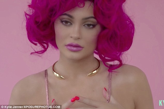 Iconic: Kylie sports a fuchsia wig with glossy pink lips as she gazes seductively at the camera