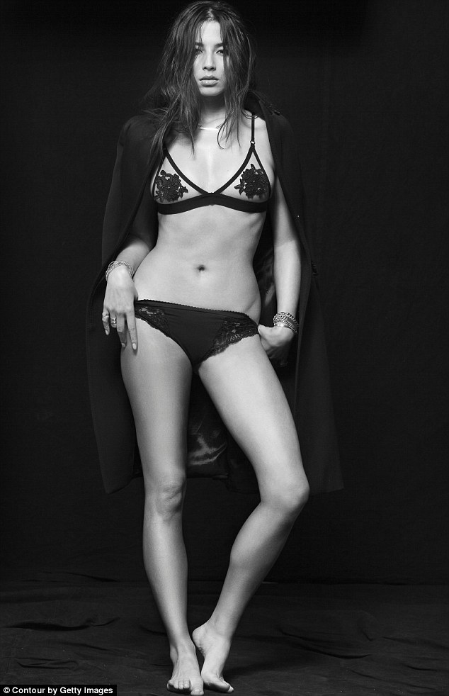 Staying warm: The Sports Illustrated model wore a heavy black coat over a two-piece lingerie set in one striking image