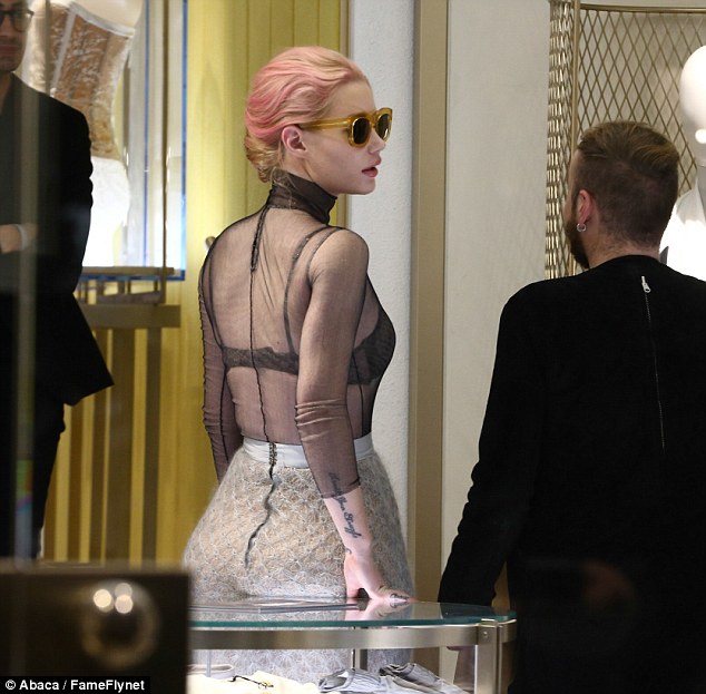 Sheer delight! The 25-year-old rapper wore a see-through top with her bra completely on display for the shopping trip 