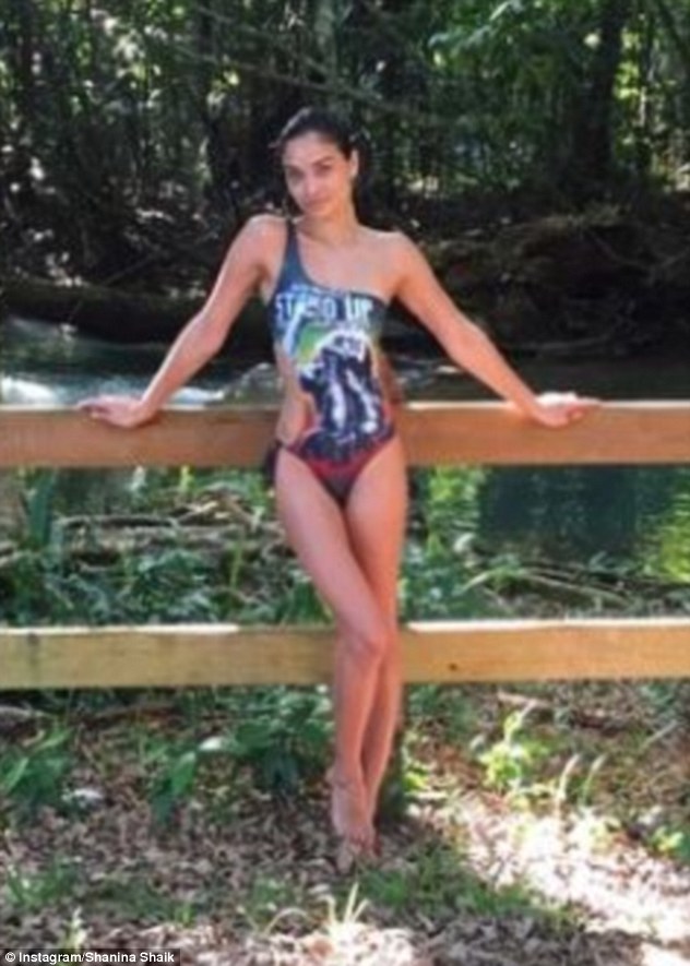 Everyday's a catwalk! She also posed against a railing in a blue one-shouldered swimsuit, placing her slender leg  against the other