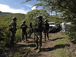 Soldiers guard an area where a mass grave was found, in Colonia las Parotas on the outskirts of Iguala, in Guerrero October 4, 2014. Authorities found the mass grave in the restive southern Mexican state of Guerrero, the state attorney general's office said on Saturday, at a time when police are scouring the area for nearly four dozen people missing after a rash of violence. Guerrero was the site of clashes involving students, police and armed men, which started late September. The state governor said earlier this week that photos showed police had taken some of the students away. Thirteen of an original group of 57 missing people re-emerged this week. Dozens are still unaccounted for.    REUTERS/Jorge Dan Lopez (MEXICO - Tags: POLITICS CIVIL UNREST EDUCATION CRIME LAW)